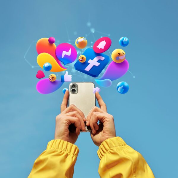 person holding phone and above it multiple social media's icon are present